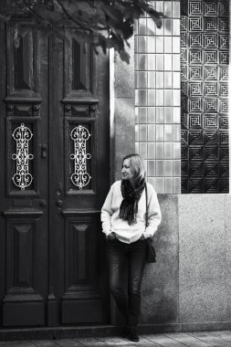 Porto, Portekiz 'de geleneksel bir evin önünde bir kadın bekliyor. Siyah beyaz fotoğraf.