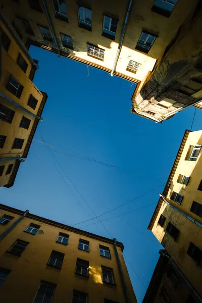 在圣彼得堡的一个庭院井里拍摄到了一个宁静的场景 深蓝色的天空与周围的建筑物形成了鲜明的对比 形成了一幅风景如画的景象 免版税图库照片