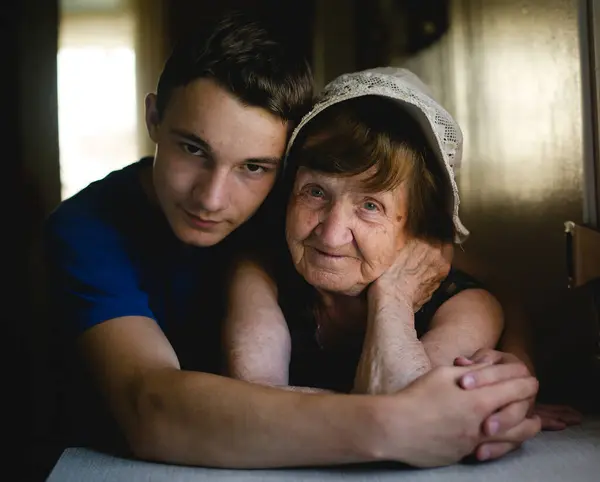 Portrait Grandmother Smiles Warmly Her Grandson Affectionately Embraces Her Capturing — Stock Photo, Image