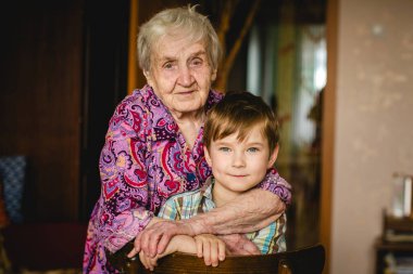 A grandma and her grandson enjoying each other's company in the comfort of their home