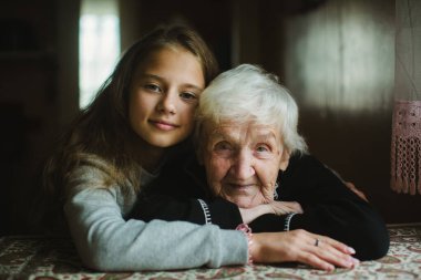 Genç torunuyla sıcak evlerinde yaşlı bir bayanın yürek ısıtan bir portresi..