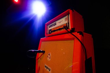 Lviv, Ukraine - November 2, 2022: Guitar Speaker Cabinets - Orange Amp on concert stage clipart