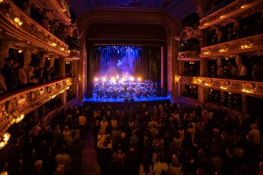 Lviv, Ukraine - March 13, 2023: Komu Vnyz - 35 Years. Concert with Symphony Orchestra in Lviv National Opera. People in Lviv Opera clipart