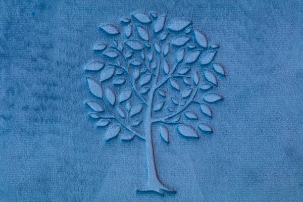 stock image tree imprint on blue velour textured fabrick for design purpose