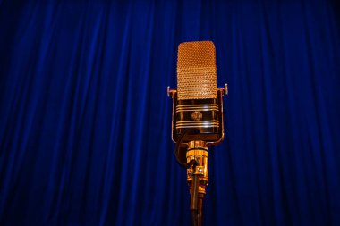Lviv, Ukraine - June 10, 2021: AEA Ribbon Microphone R44C on blue curtain background clipart