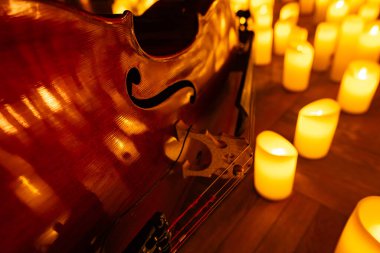 closeup of violin with lots of candles for design purpose clipart