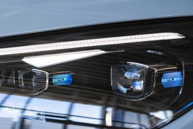 Lviv, Ukraine - November 26, 2024: Closeup of  Mercedes-Benz EQE 350 car headlight clipart