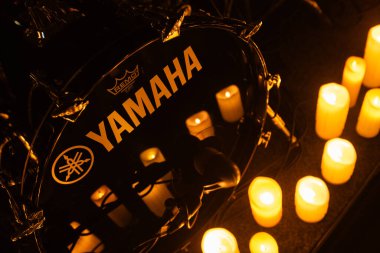 Lviv, Ukraine - February 12, 2025:  Yamaha Drum Kit on concert stage with lots of candles clipart