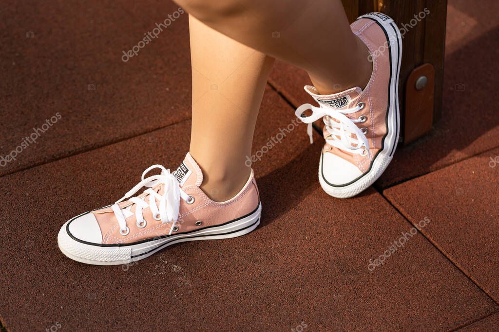 Lviv, Ukraine - April 20, 2025: Converse All Stars sneakers on woman feet
