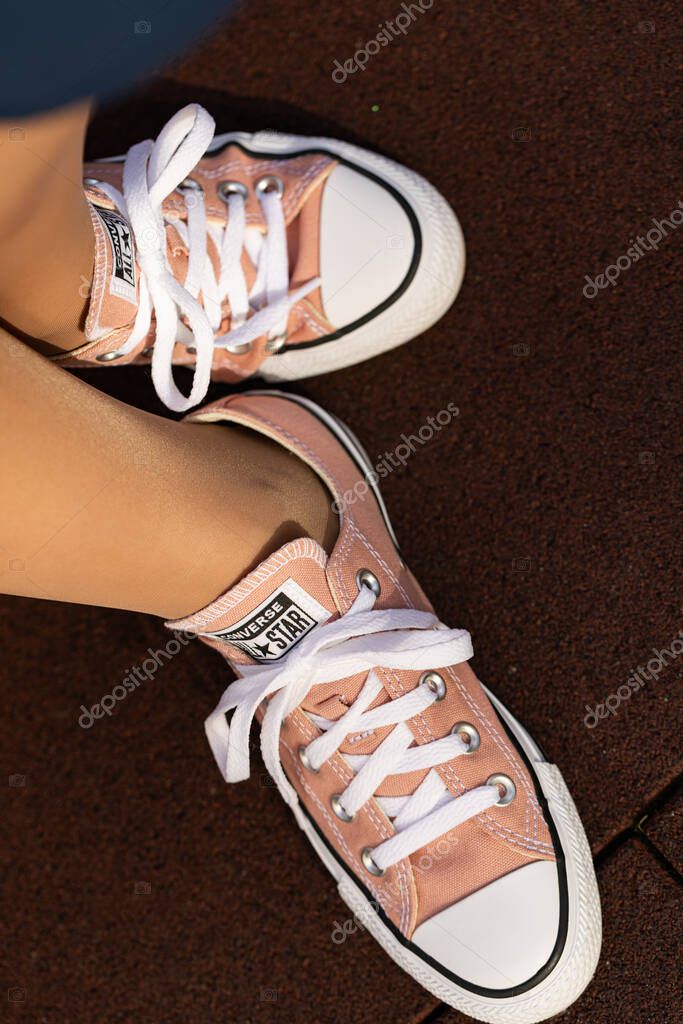 Lviv, Ukraine - April 20, 2025: Converse All Stars sneakers on woman feet