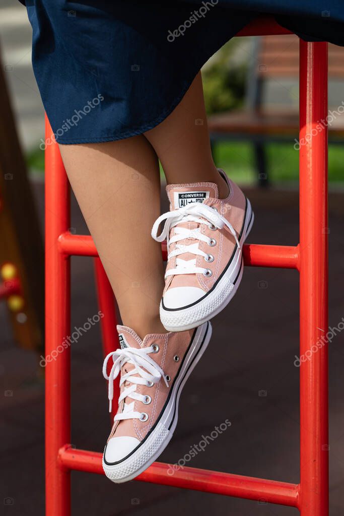 Lviv, Ukraine - April 20, 2025: Converse All Stars sneakers on woman feet