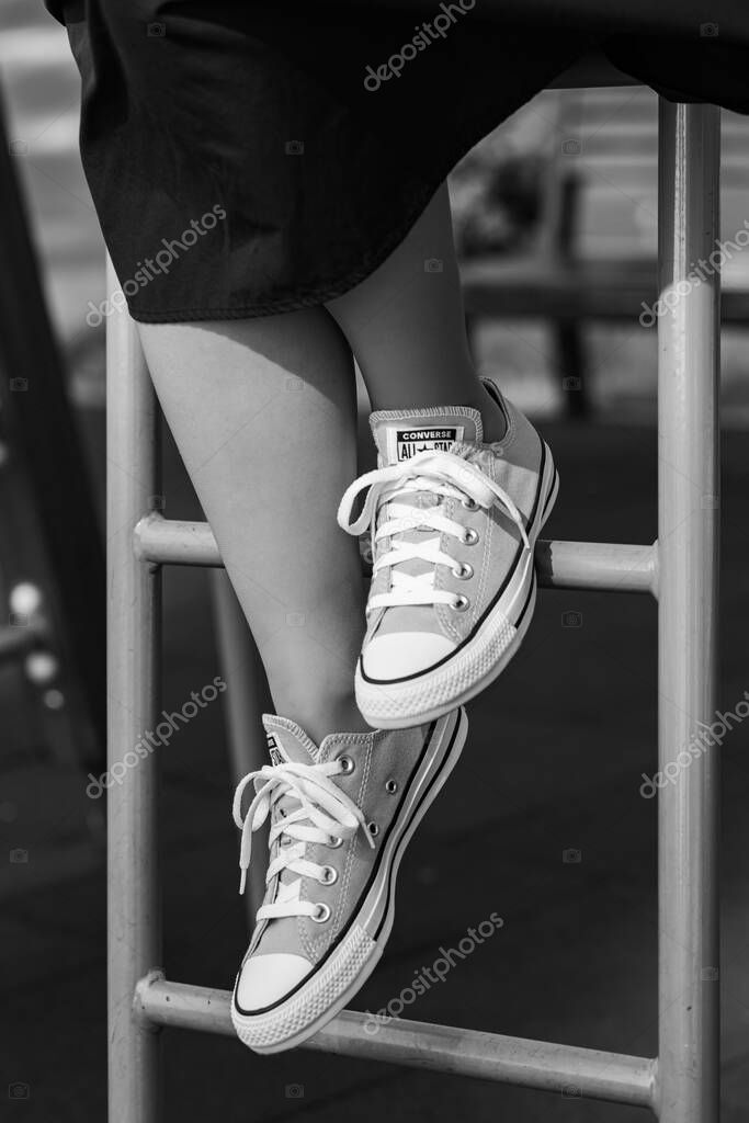Lviv, Ukraine - April 20, 2025: Converse All Stars sneakers on woman feet