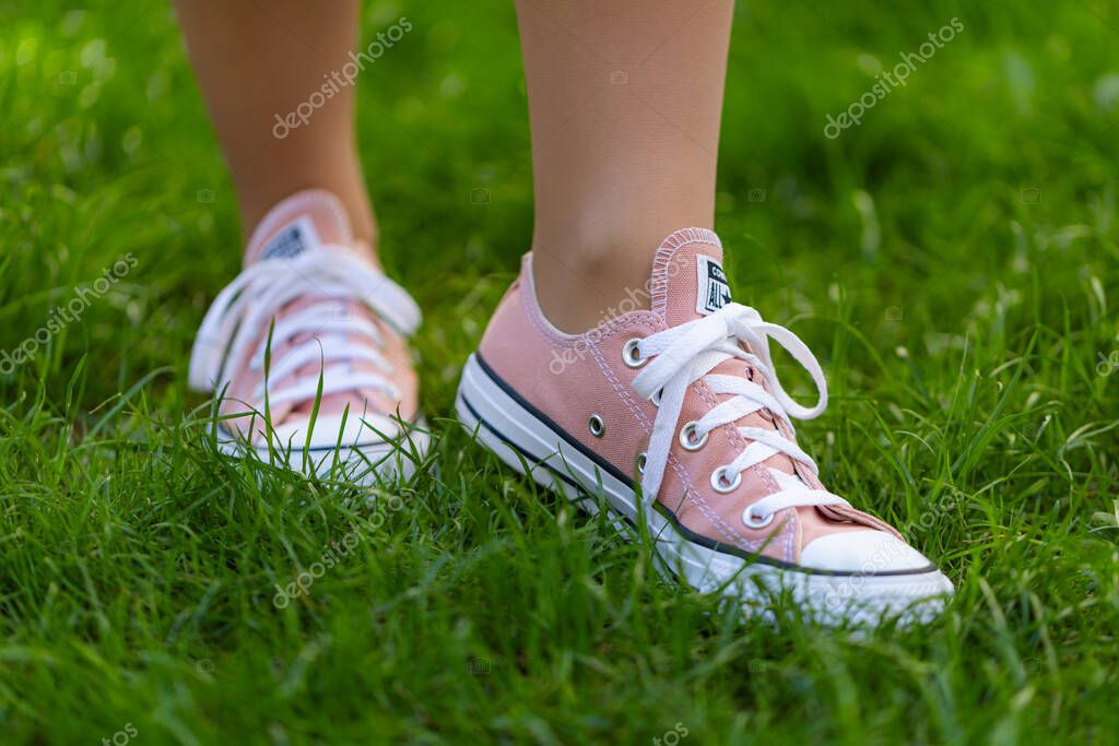 Lviv, Ukraine - April 20, 2025: Converse All Stars sneakers on woman feet