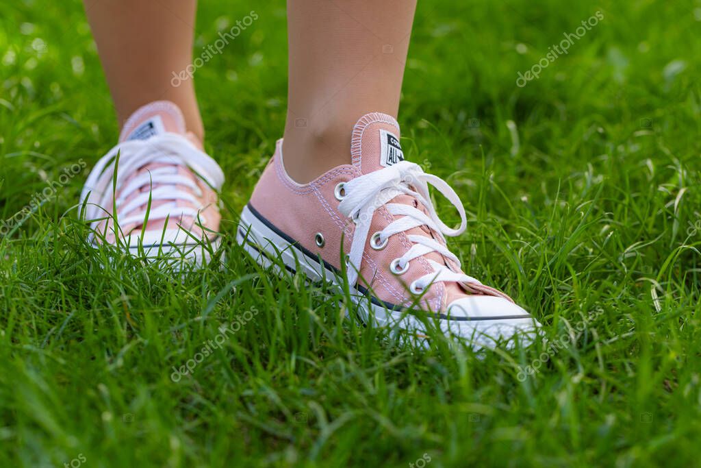 Lviv, Ukraine - April 20, 2025: Converse All Stars sneakers on woman feet