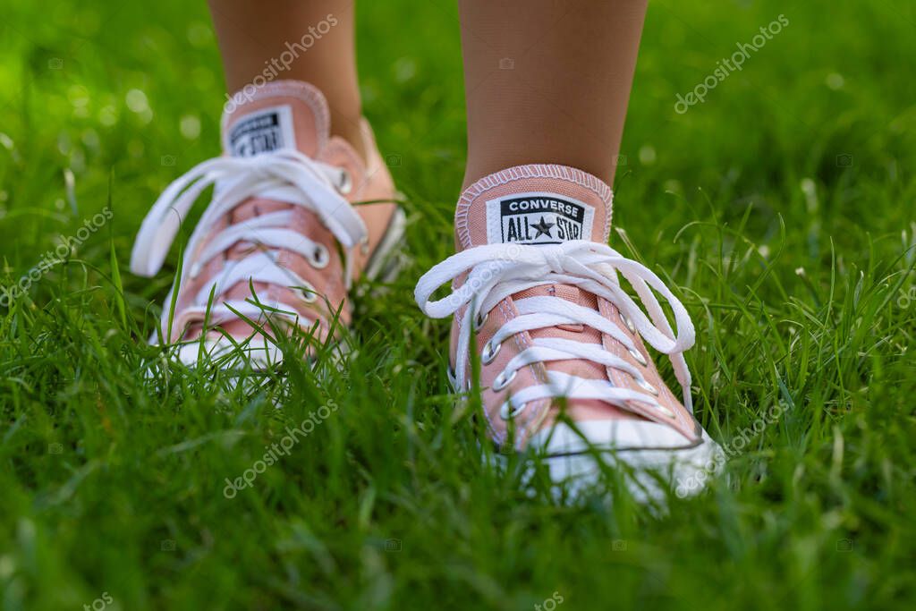 Lviv, Ukraine - April 20, 2025: Converse All Stars sneakers on woman feet