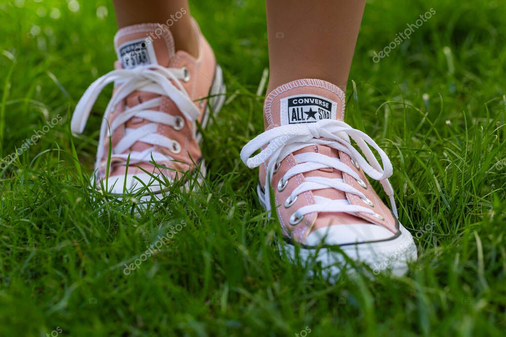 Lviv, Ukraine - April 20, 2025: Converse All Stars sneakers on woman feet