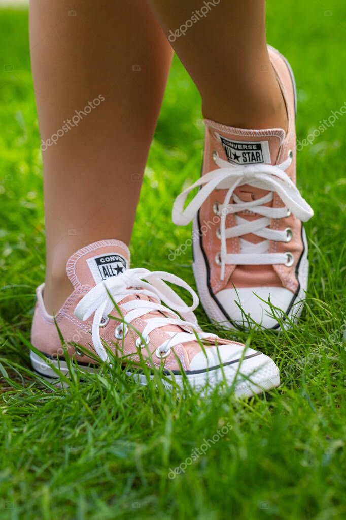 Lviv, Ukraine - April 20, 2025: Converse All Stars sneakers on woman feet