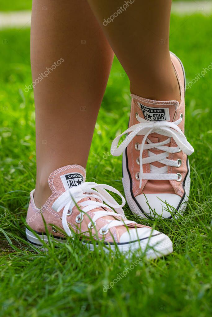 Lviv, Ukraine - April 20, 2025: Converse All Stars sneakers on woman feet