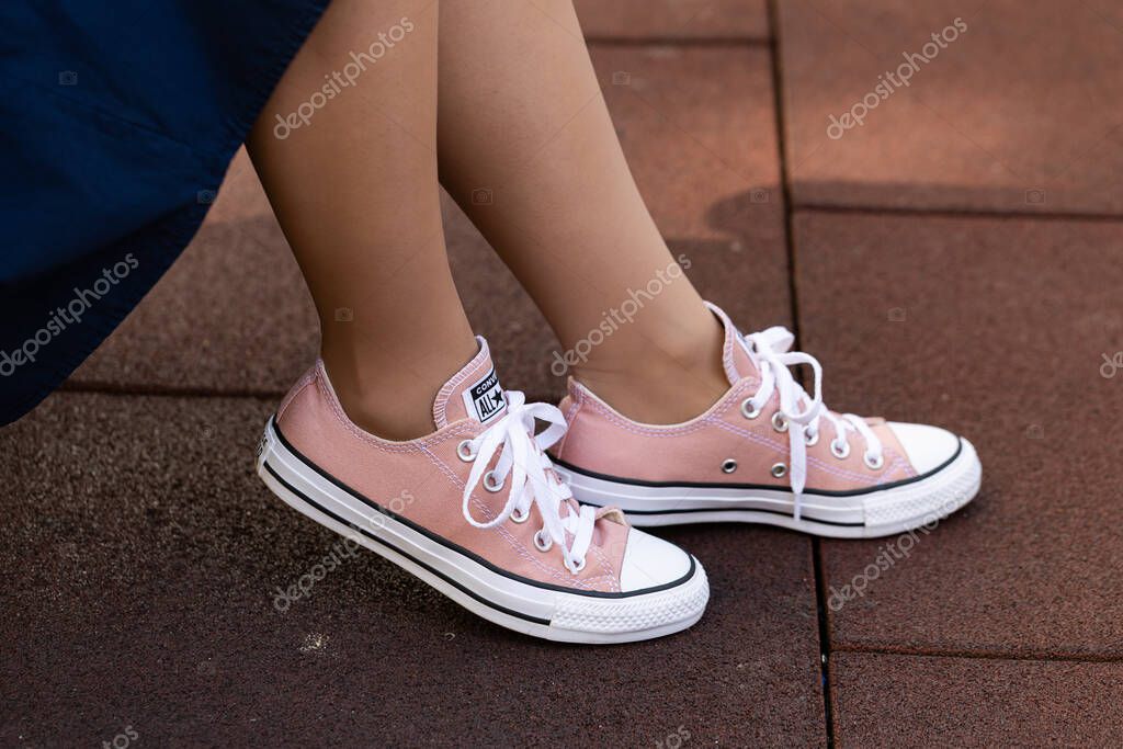 Lviv, Ukraine - April 20, 2025: Converse All Stars sneakers on woman feet