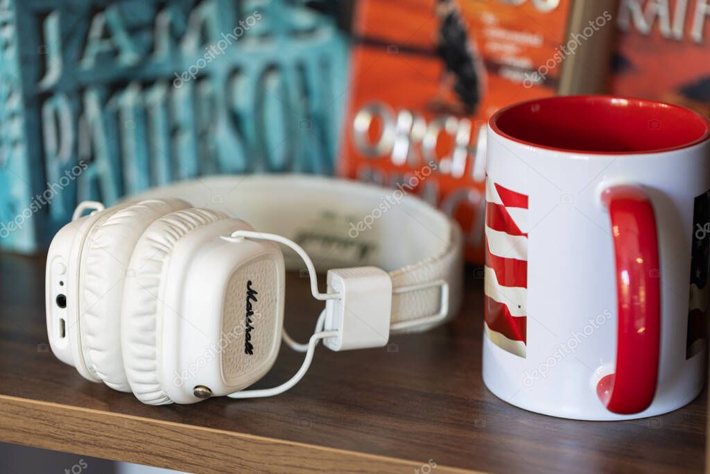 Lviv, Ukraine - April 29, 2024: white Marshall headphones on the table