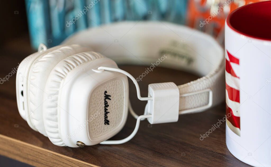 Lviv, Ukraine - April 29, 2024: white Marshall headphones on the table