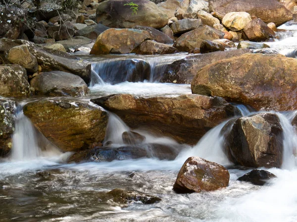 Beautiful waterfall with blurred crystalline waters photographed in long exposure. Selective Focus