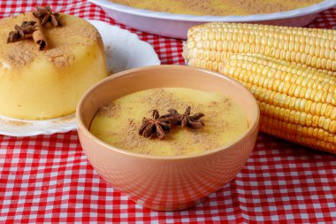 Curau, mısır tatlısı kreması ve Brezilya mutfağının tipik bir çeşidi, seramik kaseye konmuş ahşap masa. Kapat.