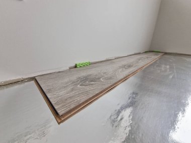 Close up of laminate flooring plank ready for flooring installation