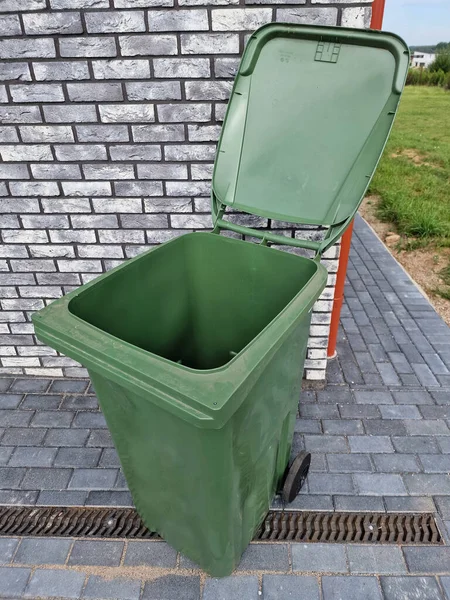 Pusty Zielony Plastikowy Pojemnik Śmieci Indywidualnego Użytku Przed Nowoczesnym Domem — Zdjęcie stockowe