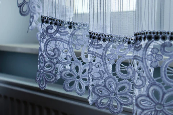 Close up of curtain part. curtain in window frame, interior detail. Beautiful transparent white curtains in an apartment.