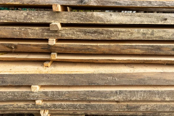 stock image Wood timber construction material for background and texture. Perspective angle of wooden planks. sawmill outdoors. Wood timber stack of wooden blanks construction material. Industry. 