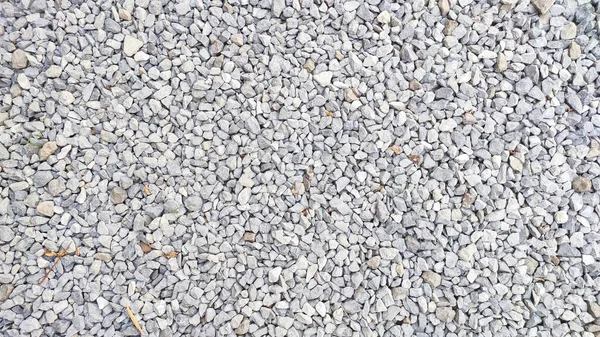 花崗岩の砂利の質感 小さな砂利で作られた道路の表面 灰色の小石を織物 粉砕材料の背景 — ストック写真