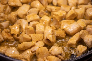 Pieces of chicken on pan. Meat food. Preparing dinner on frying pan. Delicious meal.	
