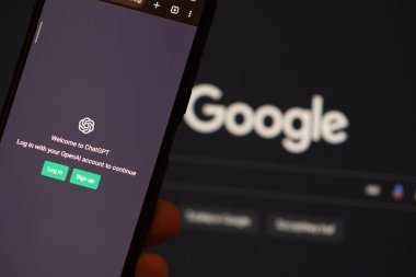 Warsaw Poland - February 24, 2023: Webpages of chat bot ChatGPT, OpenAI chatbot, and Google logo are seen on smartphones and background