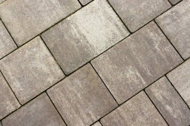 Gri kaldırım taşları. Paving yüzey yolu. Büyük gri beton tuğlalardan yapılmış doku.