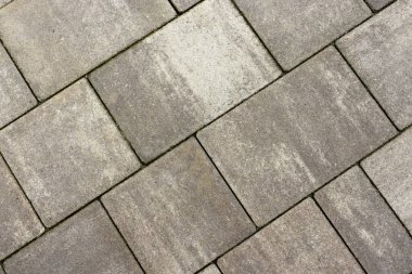 Gri kaldırım taşları. Paving yüzey yolu. Büyük gri beton tuğlalardan yapılmış doku.