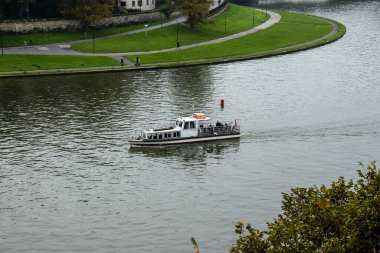 Wroclaw, Polonya - 18 Ekim 2023: Yeşillik ve tarihi mimari ile çevrili, gezmek ve gezmek için ideal bir nehir manzaralı bir tekne manzarası.