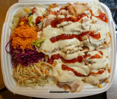 Lezzetli tabakta taze tavuk şeritleri rengarenk sebzeler ve yemek sevenler ve aşçılar için ideal soslar var.