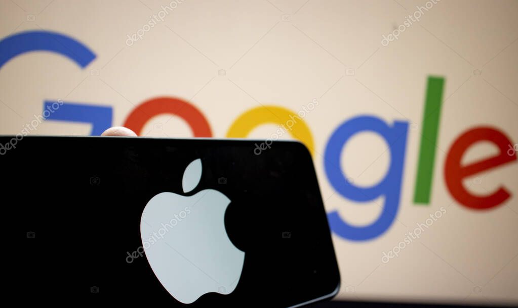 Warsaw Poland - September 20 2024: A smartphone displaying the Apple logo is positioned in front of the Google logo illustrating the tech rivalry between these two tech giants.