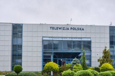 Rzeszow Poland - September 20 2024: A modern building of Telewizja Polska with a green surrounding showcasing contemporary architecture. Ideal for editorial use. clipart