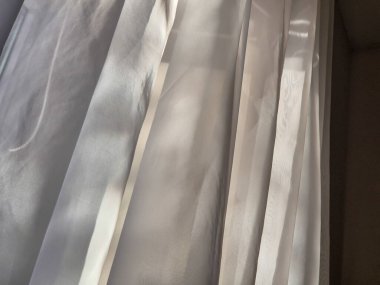 Perdelerin arasından süzülen güneş ışığı güzel aydınlatılmış bir odada yumuşak ve sakinleştirici bir atmosfer yaratıyor.