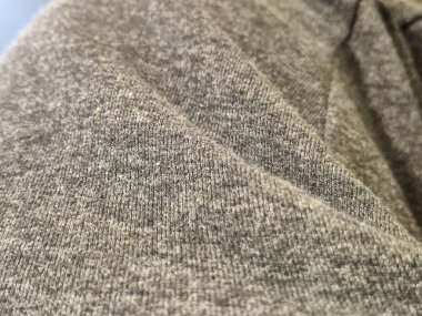 İnce detaylar ve yumuşak lifleri gösteren desenli gri bir kumaşın yakın çekimi. Moda dokusu veya kumaş kavramları için ideal.
