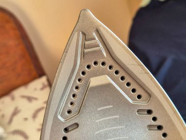 Close-up of a modern irons soleplate showcasing its design and features clipart