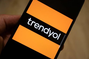 Warsaw Poland - January 17 2025: A close-up of a smartphone displaying the trendyol logo against a vibrant background symbolizing modern digital shopping. clipart