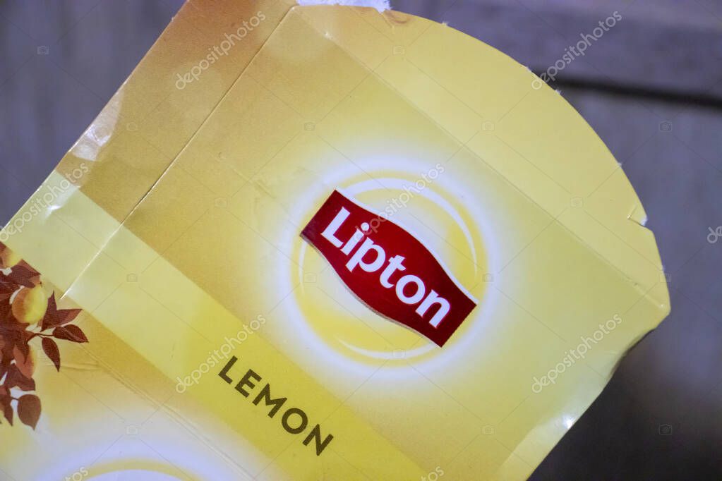 Warsaw Poland - January 19 2025: A close-up of a yellow Lipton lemon tea packaging showcasing vibrant colors and brand identity perfect for food and beverage themes.