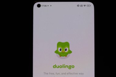 Varşova Polonya - 10 Mart 2025: Duolingo uygulaması dil öğrenmek için dost bir baykuş maskotu gösteren bir akıllı telefonda sergilendi.