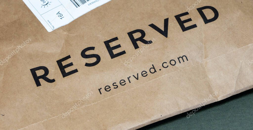 Warsaw Poland - March 3 2025: Brown paper package featuring the Reserved brand logo symbolizing fashion retail and online shopping.