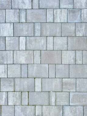 Taşların yapısını ve yapısını gösteren gri tuğla kaldırımın yakın plan görüntüsü mimari veya arka plan projeleri için idealdir..
