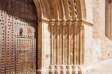 Süslü sütunların ve Valencia 'da mimari detayların ve kültürel mirasın sergilendiği büyük ahşap bir kapının yer aldığı tarihi bir binanın girişi..