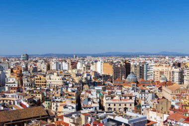 Valencia şehir çatılarının panoramik manzarası açık mavi gökyüzü altında çeşitli mimari ve canlı şehir hayatı seyahat ve şehir manzarası temaları için ideal..